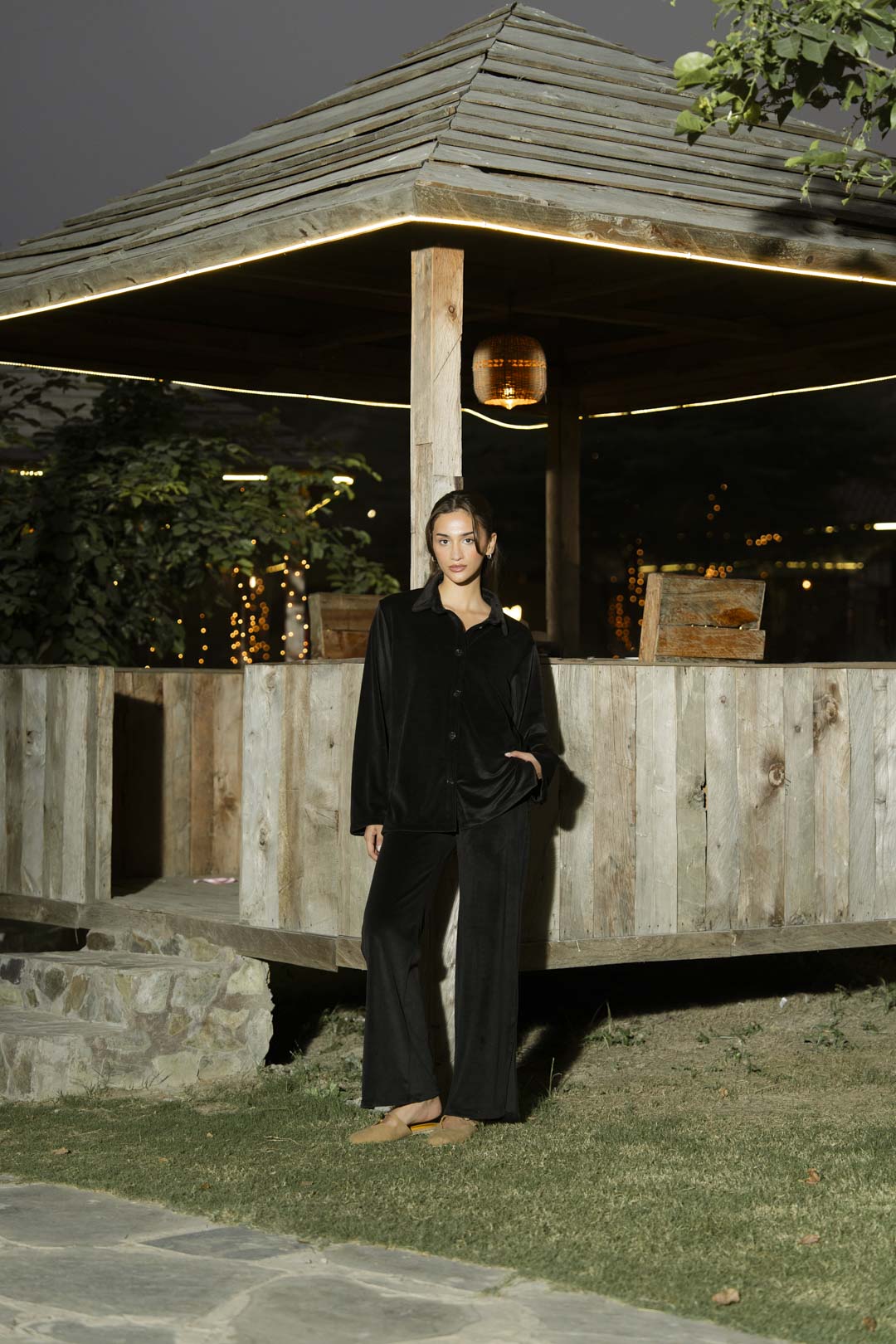 Model wearing black velvet 2 piece co-ord set outdoors, full-length front view.