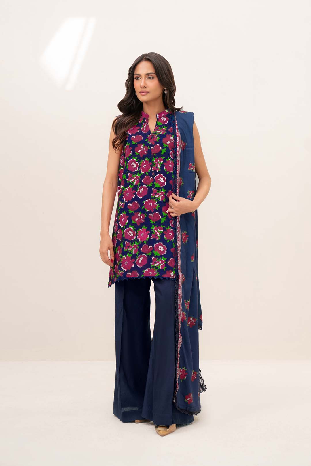 Model wearing blue printed linen 3 piece suit with matching printed dupatta, full front view in studio.