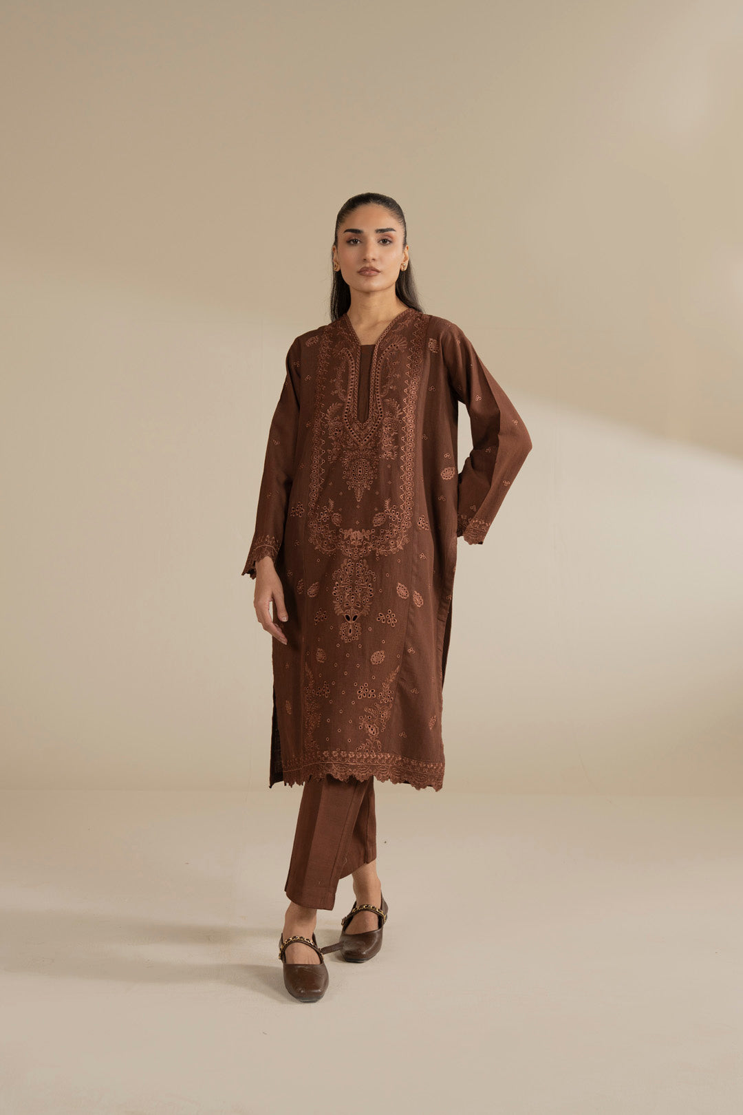 Model wearing brown solid embroidered 2 piece suit, full front view with straight trousers in studio.