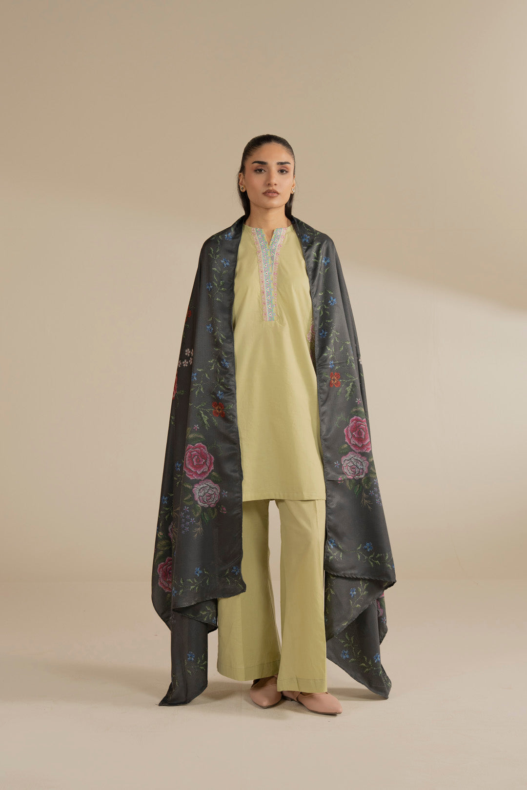 Model wearing dark green printed dupatta draped over a light outfit, full front view in studio setting.