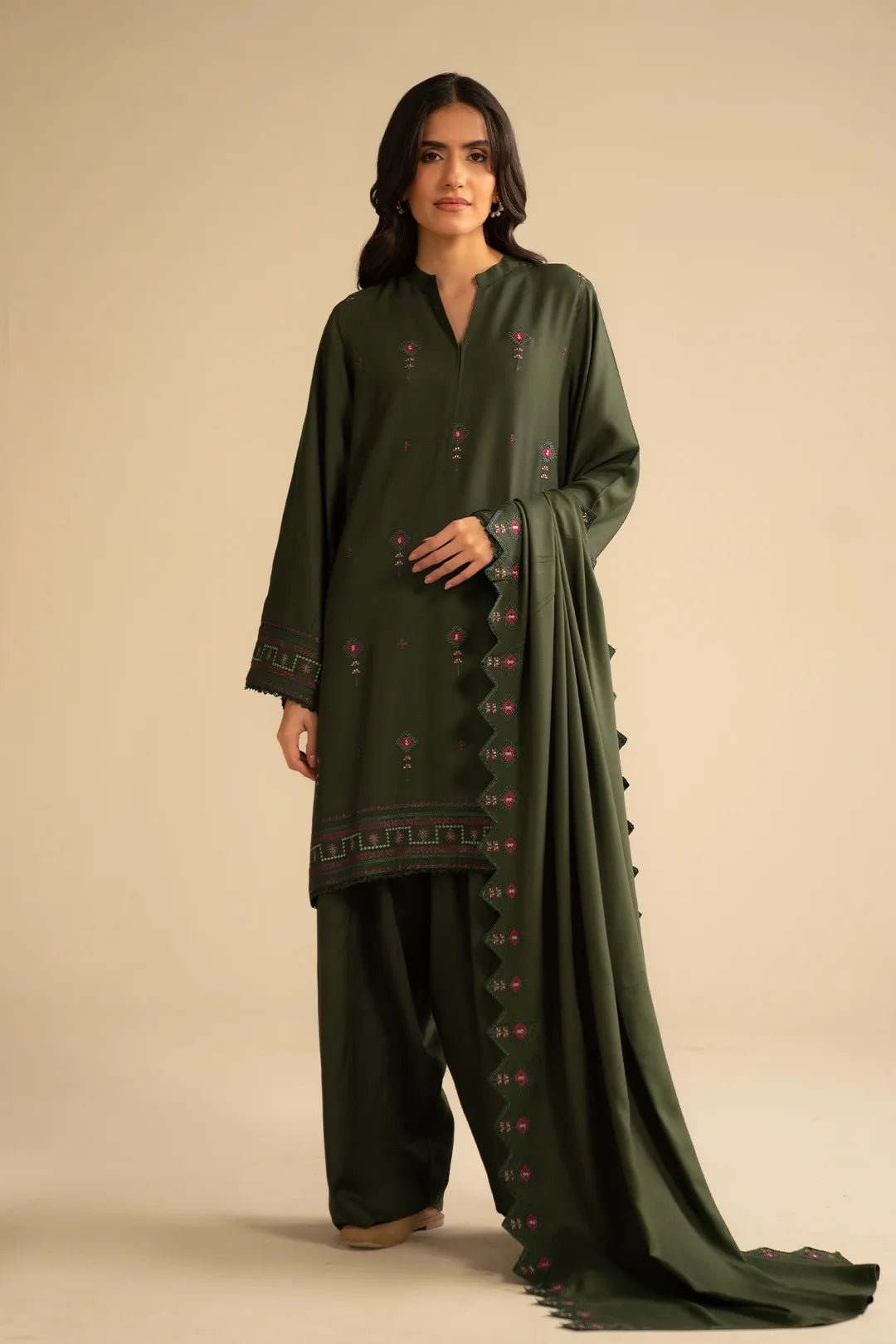 Model wearing deep green solid embroidered linen 3 piece suit with matching dupatta, full front view in studio.
