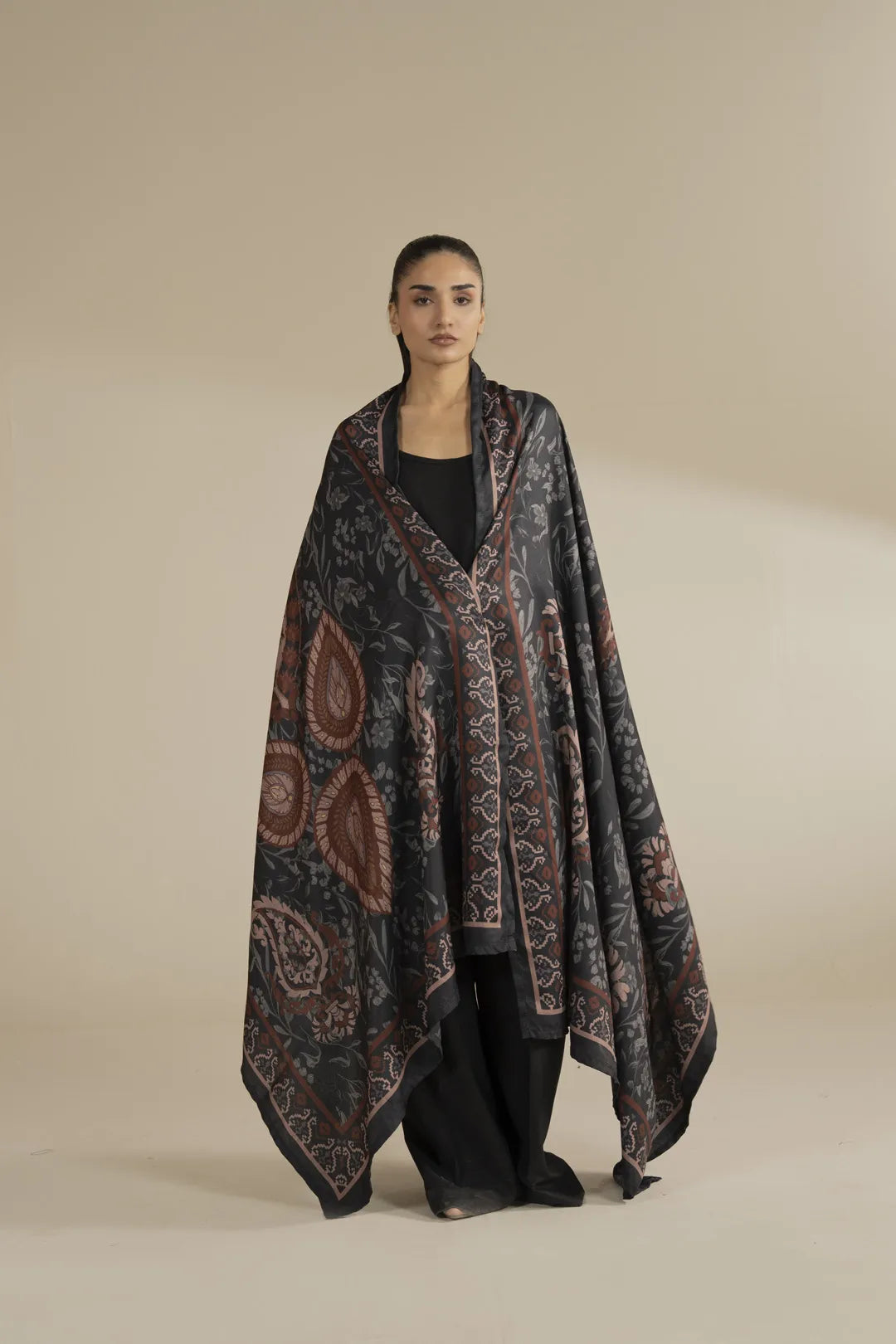Model wearing grey printed herringbone shawl with intricate pattern drape, full front view in studio setting