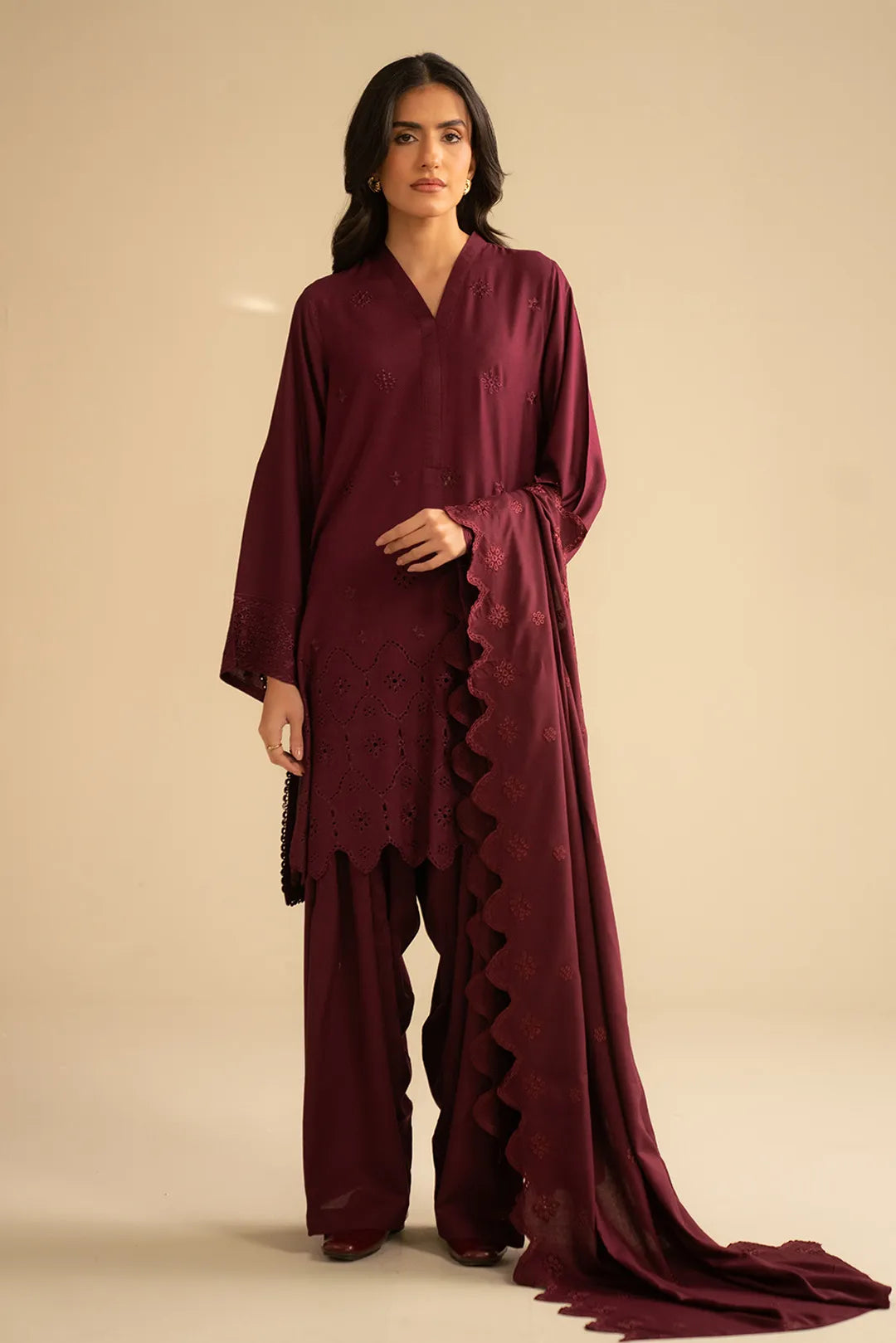 Model wearing maroon chikankari embroidered linen 3 piece suit with matching dupatta, full front view in studio.