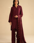 Model wearing maroon chikankari embroidered linen 3 piece suit with matching dupatta, full front view in studio.