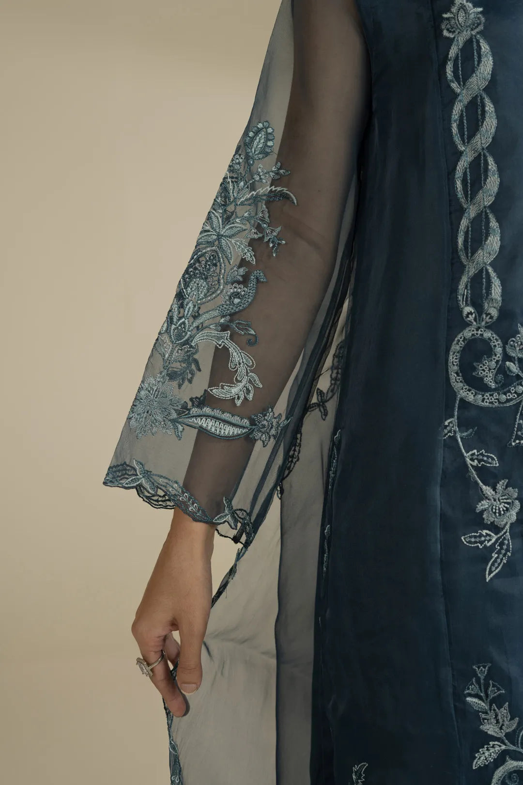 Model wearing maroon festive suit with flowy dupatta and matching trousers