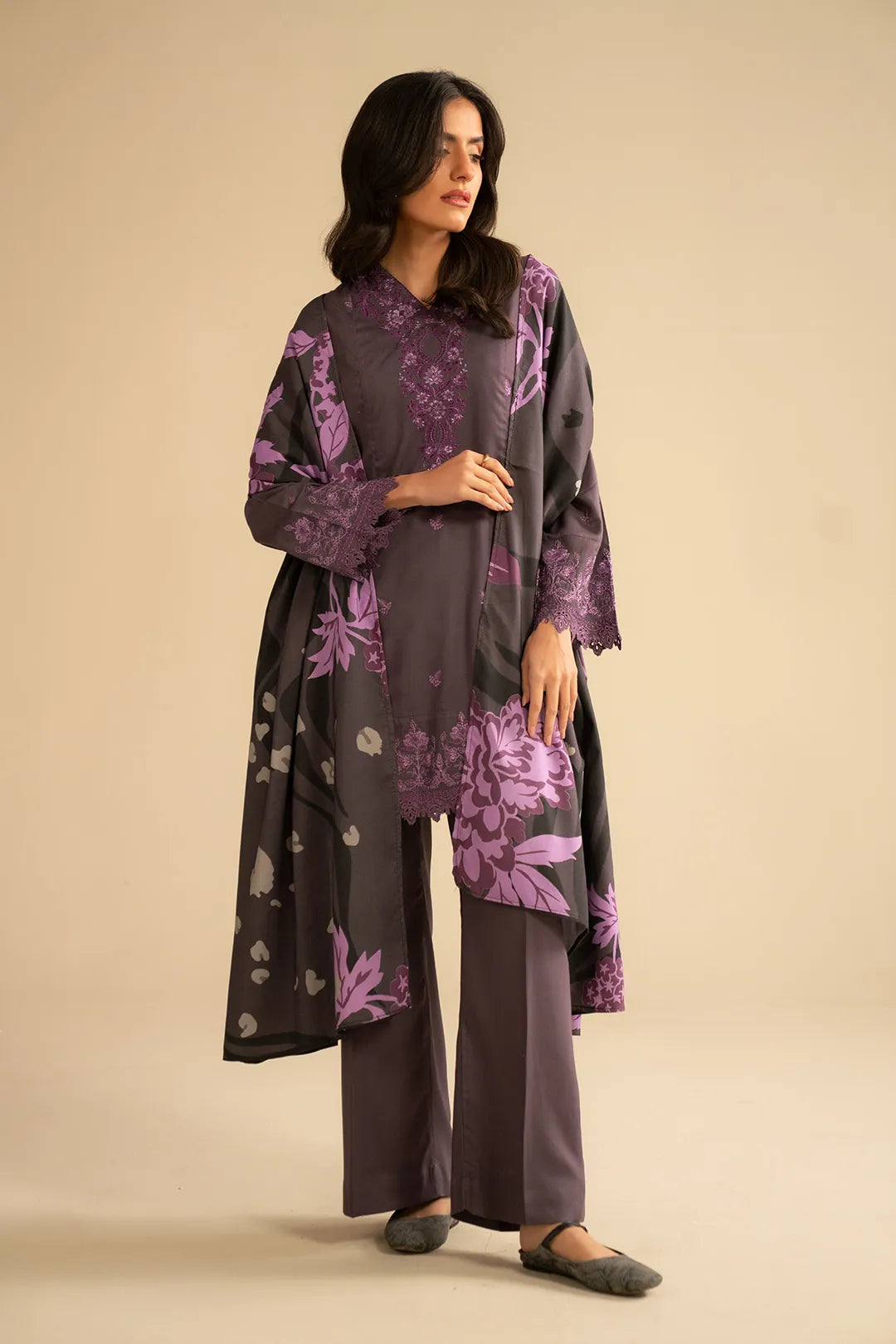 Model wearing purple 3 piece embroidered linen suit with printed shawl, full front view in studio setting