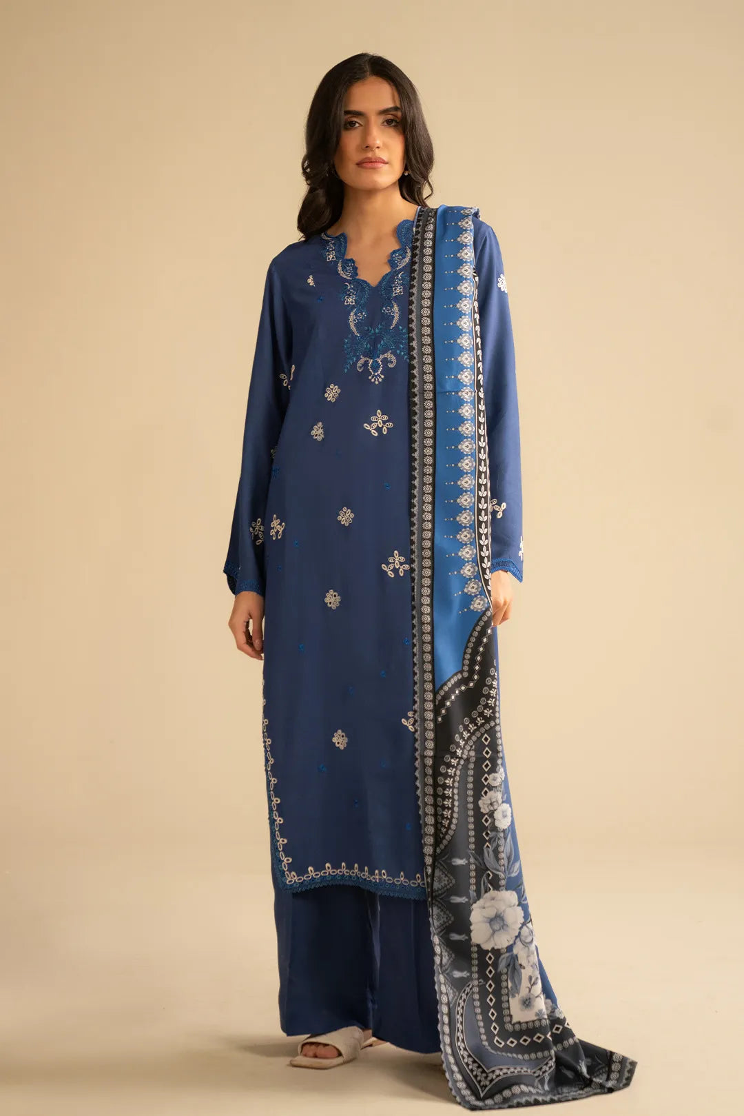 Model wearing royal blue 3 piece embroidered linen suit with printed shawl, full front view in studio