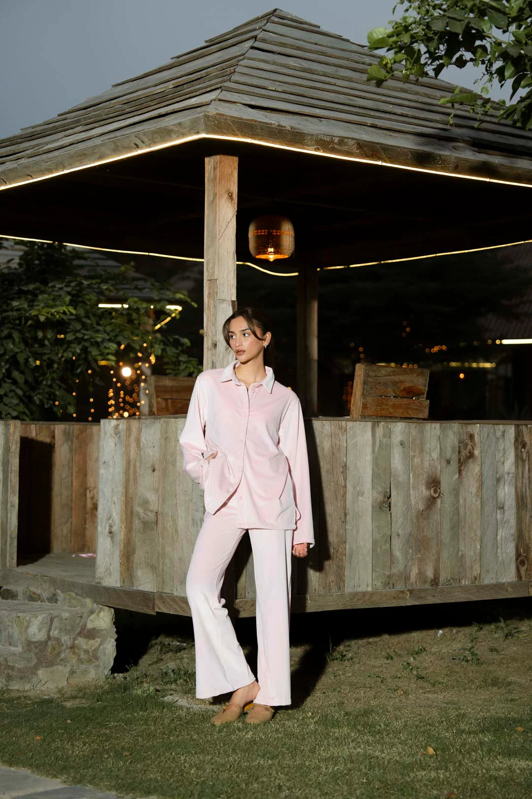 Model wearing soft pink velvet co-ord set outdoors, full-length front view with relaxed fit silhouette