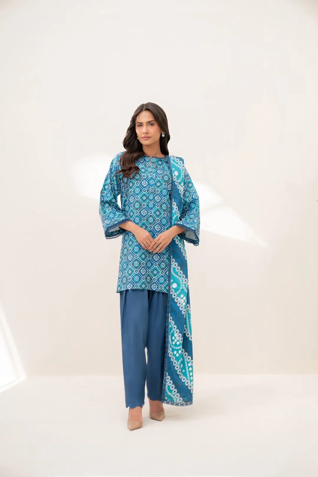 Model wearing teal geometric printed linen 3-piece unstitched suit with printed dupatta