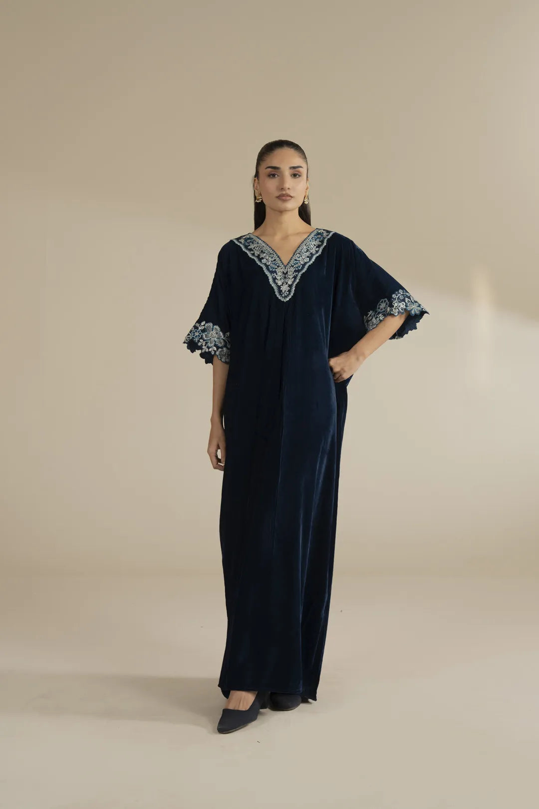 Navy velvet kaftan with silver embellished neckline shown as a full-length studio look.