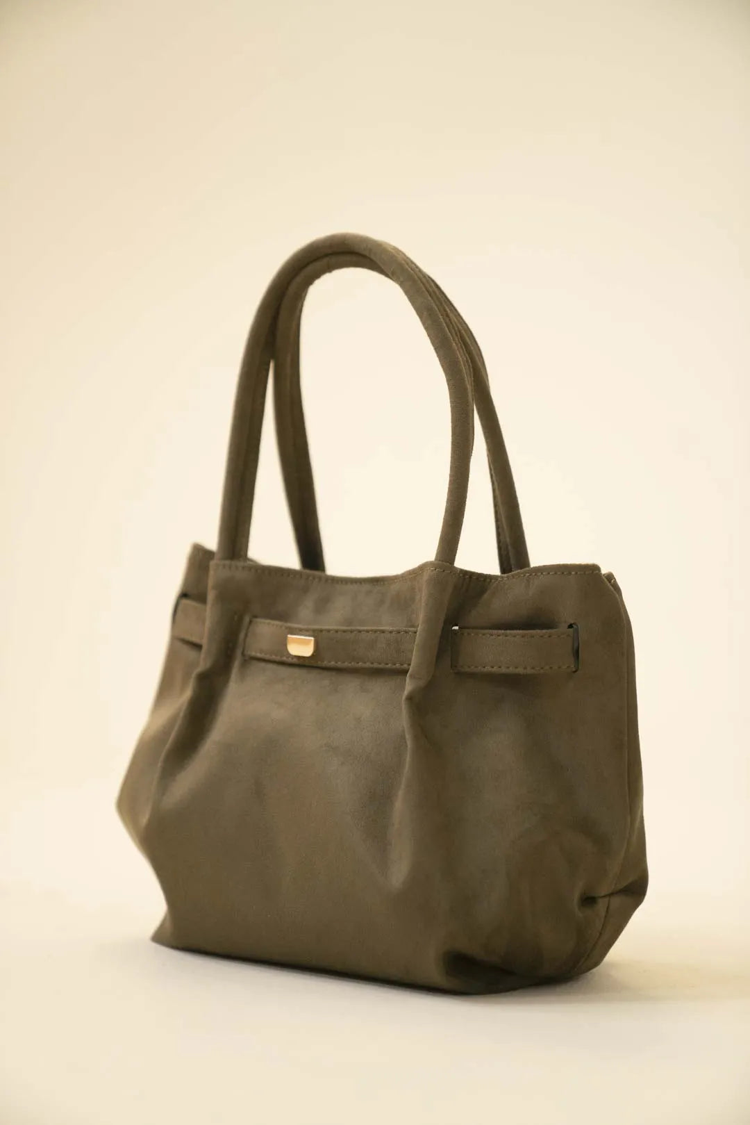 Olive green suede tote bag with double shoulder handles and a soft slouchy silhouette on a neutral background.