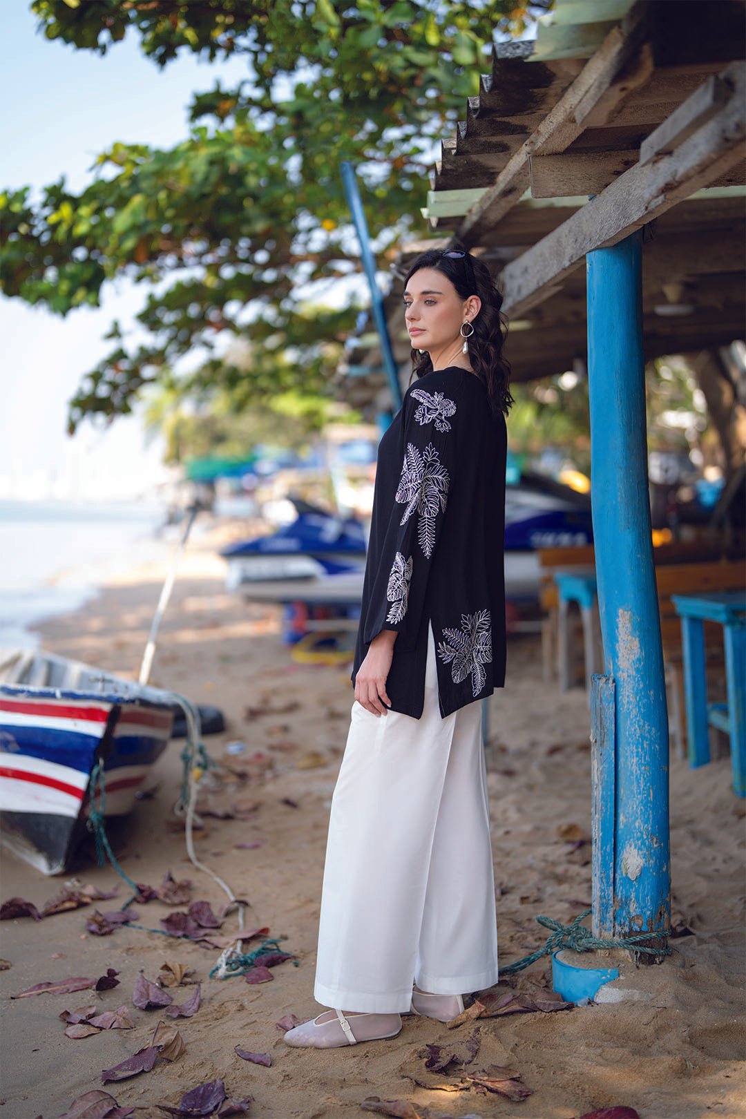 Outdoor full-length view of women’s black linen shirt with contrast embroidery