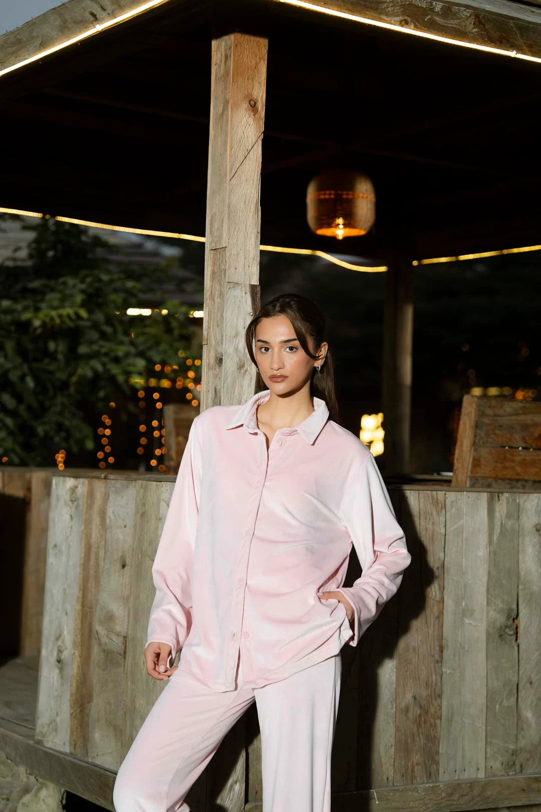 Outdoor shot of soft pink velvet co-ord set highlighting the relaxed, chic styling