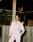Outdoor shot of soft pink velvet co-ord set highlighting the relaxed, chic styling