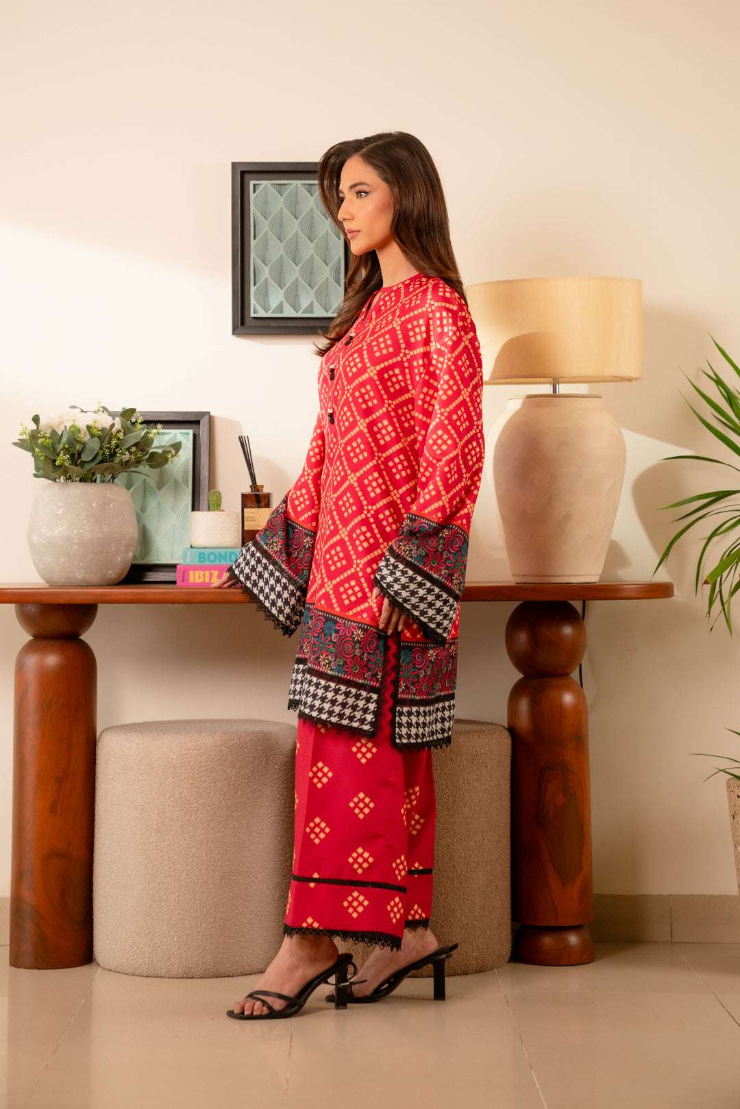Pakistani cambric suit – traditional red and black printed dress with intricate detailing for a striking look.