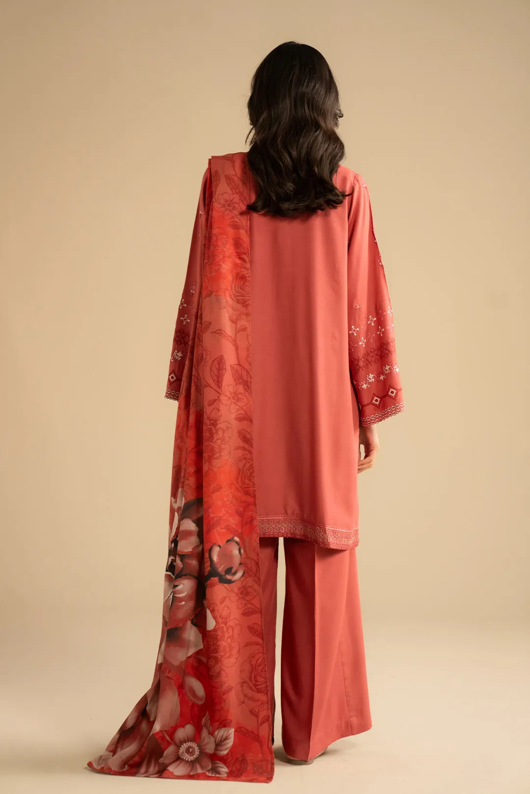 Printed shawl draped over the shoulder, showing bold floral pattern and border contrast.