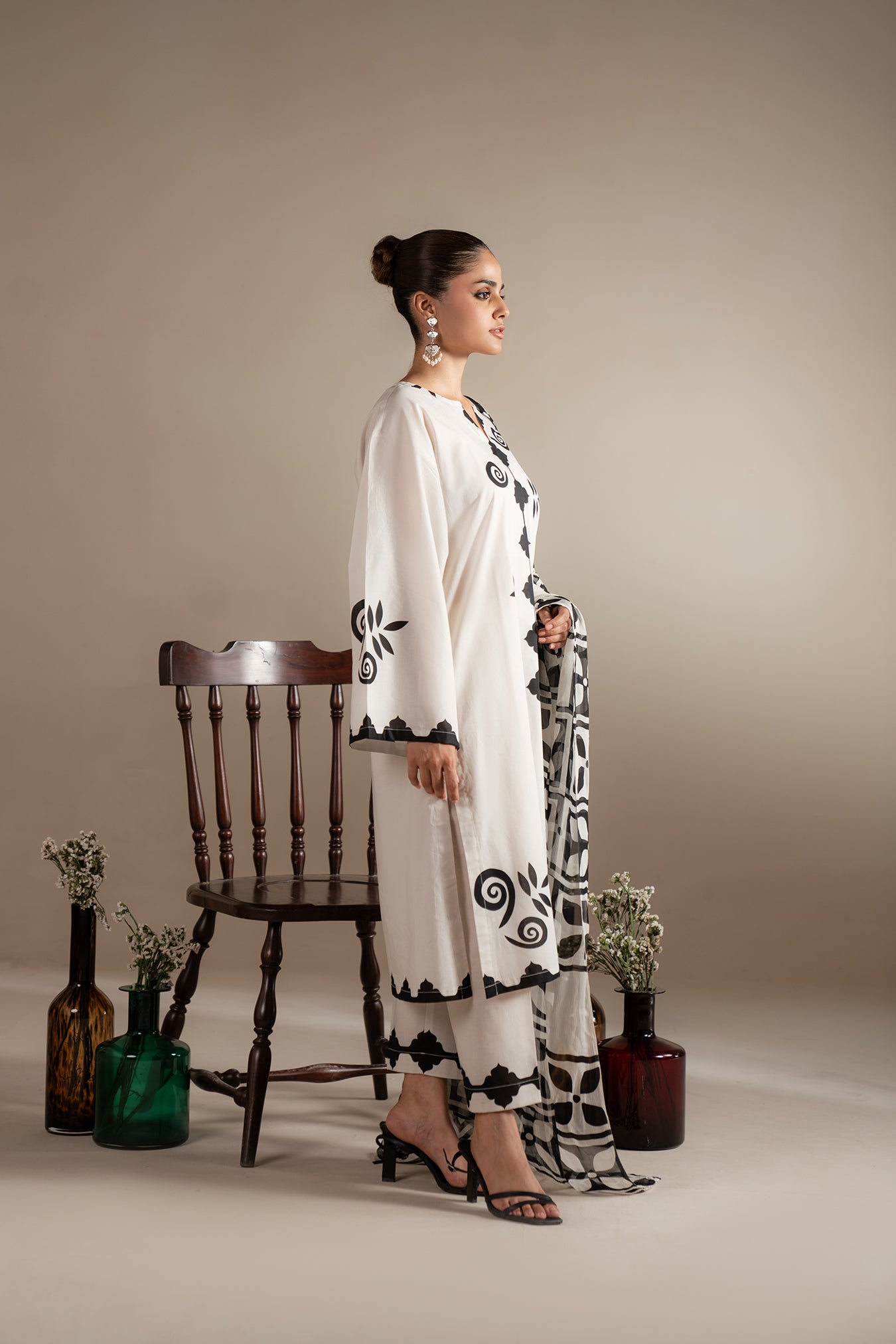 Ready-to-wear monochrome lawn suit featuring bold black prints on soft white fabric