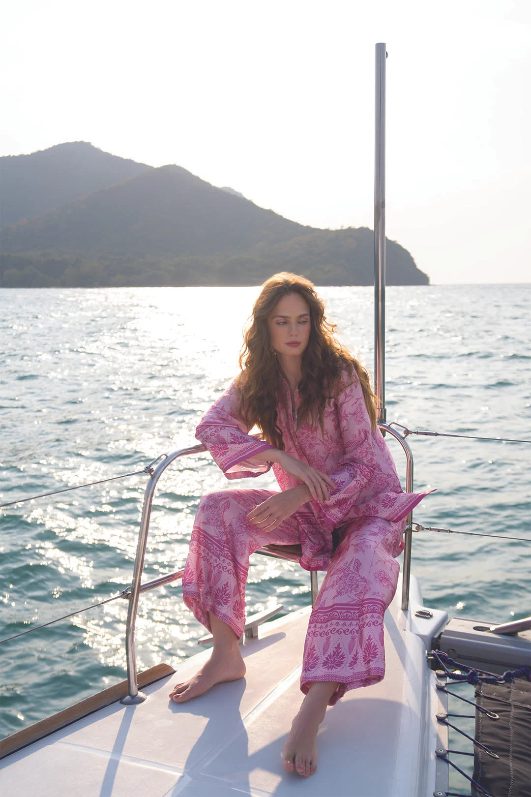 Seated view of pink printed co-ord set styled for resort and festive wear