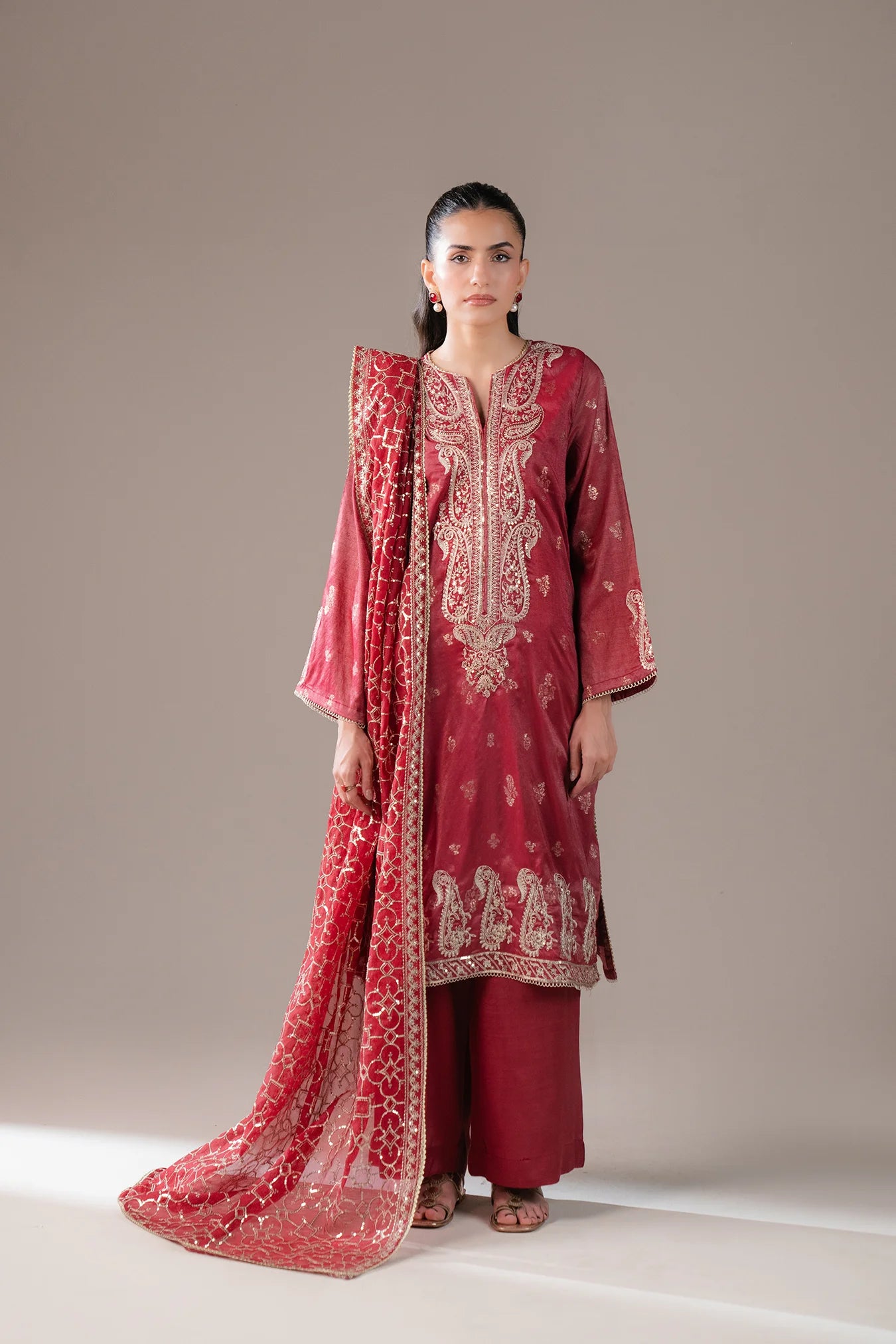 Shop red 3 piece embroidered jamawar suit for women – festive ready outfit with organza dupatta and plain trousers, perfect for Eid or wedding events in Pakistan.
