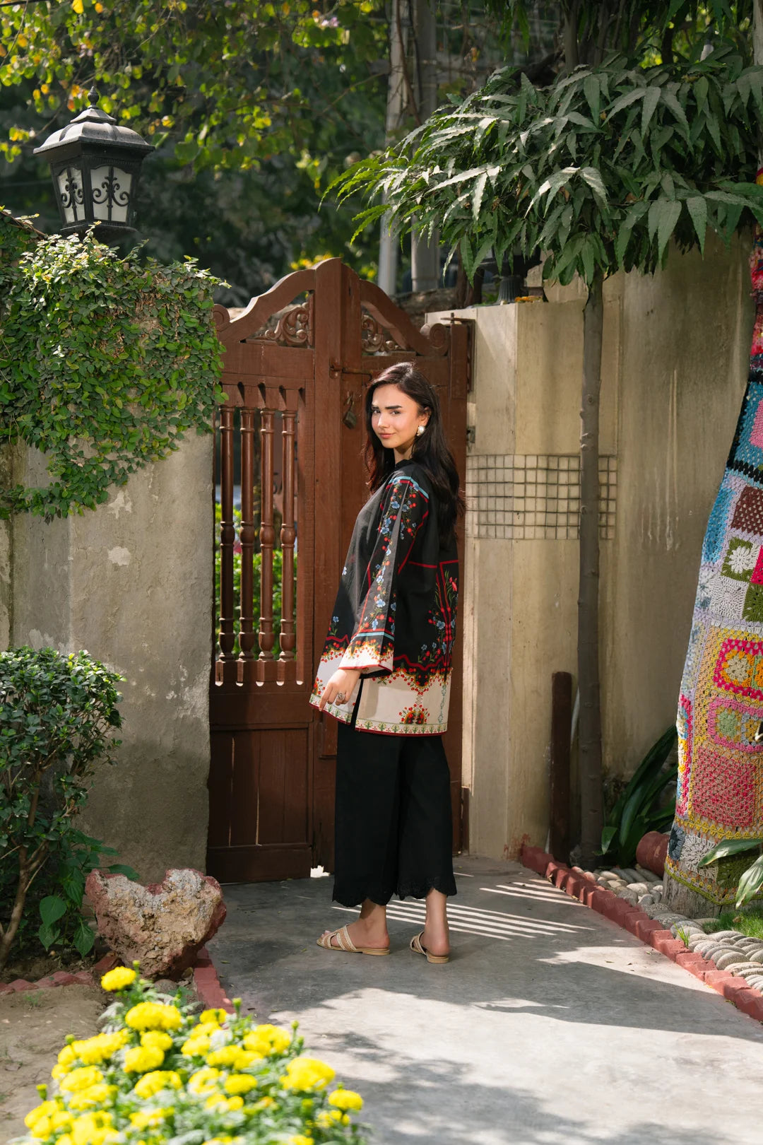 Side angle of black pret shirt with red border print