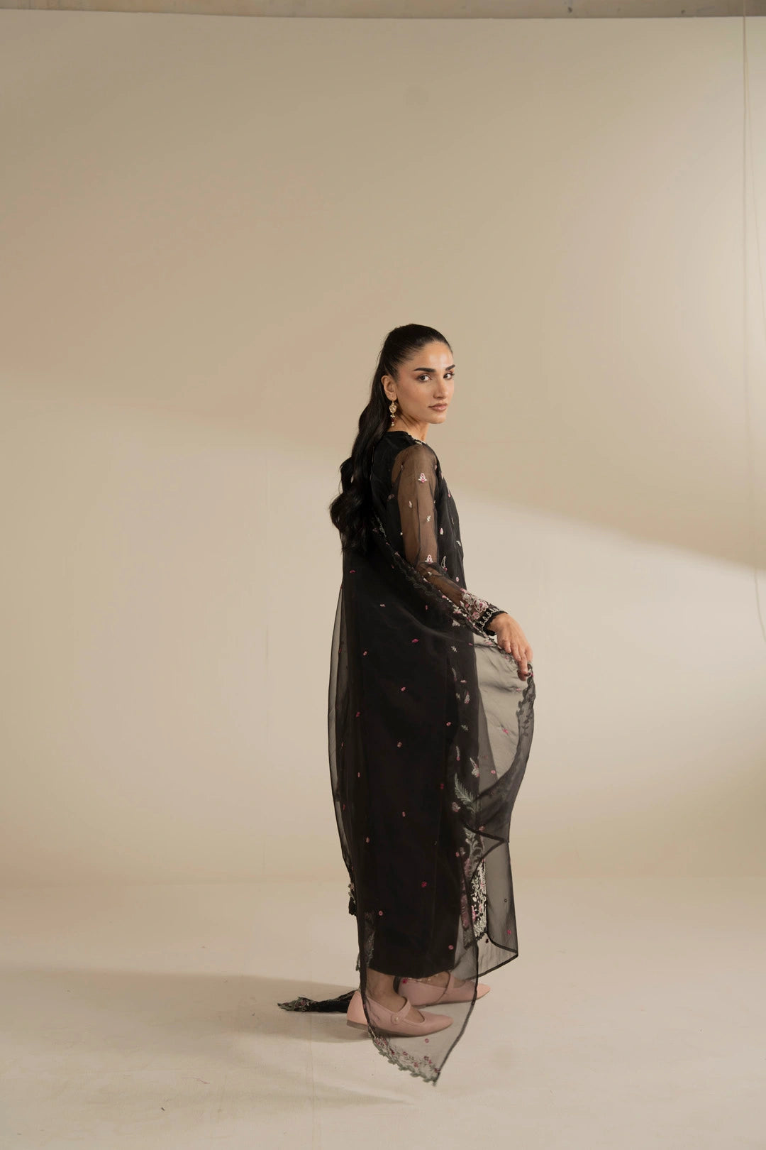 Side angle of embroidered organza suit highlighting straight silhouette and formal fall.