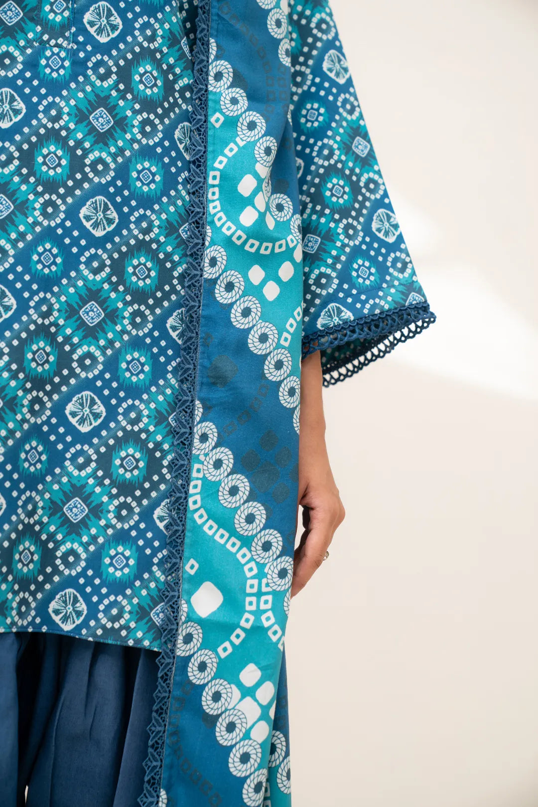 Side detail of teal printed linen shirt sleeve with matching printed dupatta border
