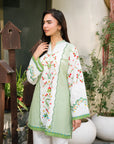 Side pose of printed cambric shirt for women in soft green tones