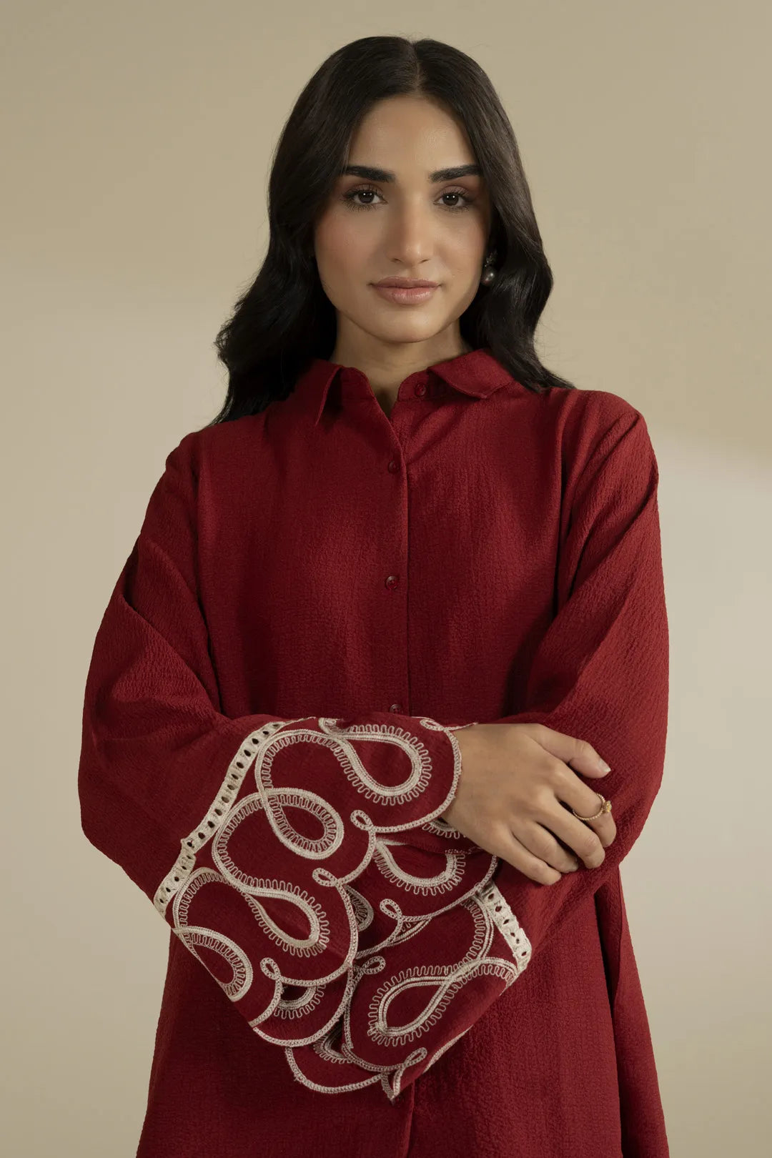 Side pose of relaxed fit red 2 piece suit for women