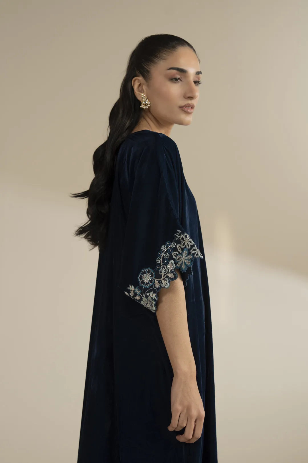 Side profile shot showing the kaftan’s relaxed fall and straight silhouette.