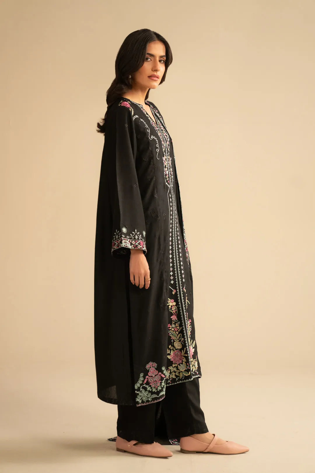 Side view of black embroidered linen suit showing flowy silhouette and dupatta drape