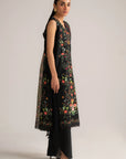 Side view of black lawn suit with flowing voile dupatta and dark trousers