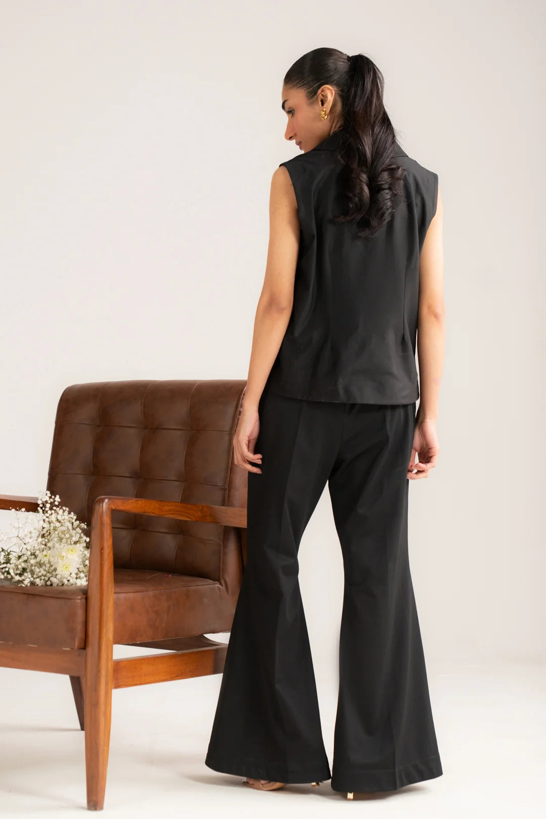 Side view of black solid co-ord set with cropped vest and flowy wide-leg pants
