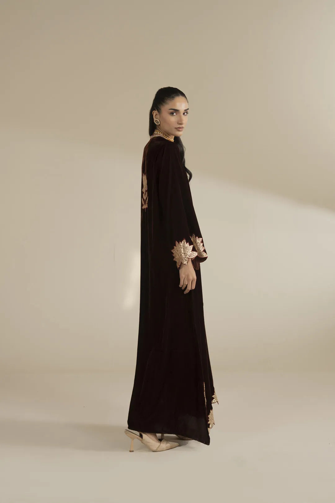 Side view of black velvet embroidered kaftan showing full length and drape