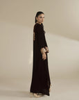Side view of black velvet embroidered kaftan showing full length and drape