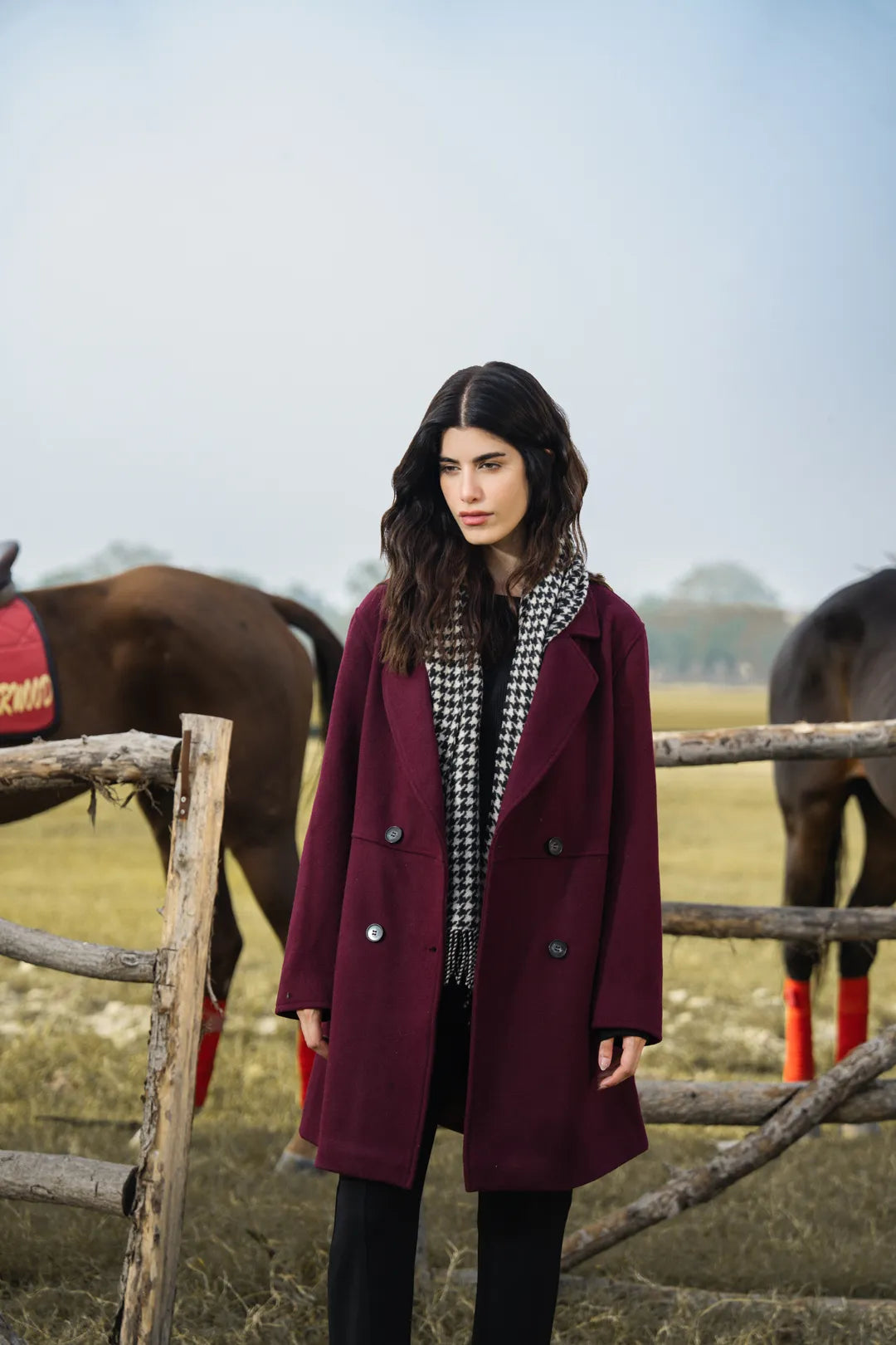 Side view of knee-length maroon coat showing straight silhouette and drape