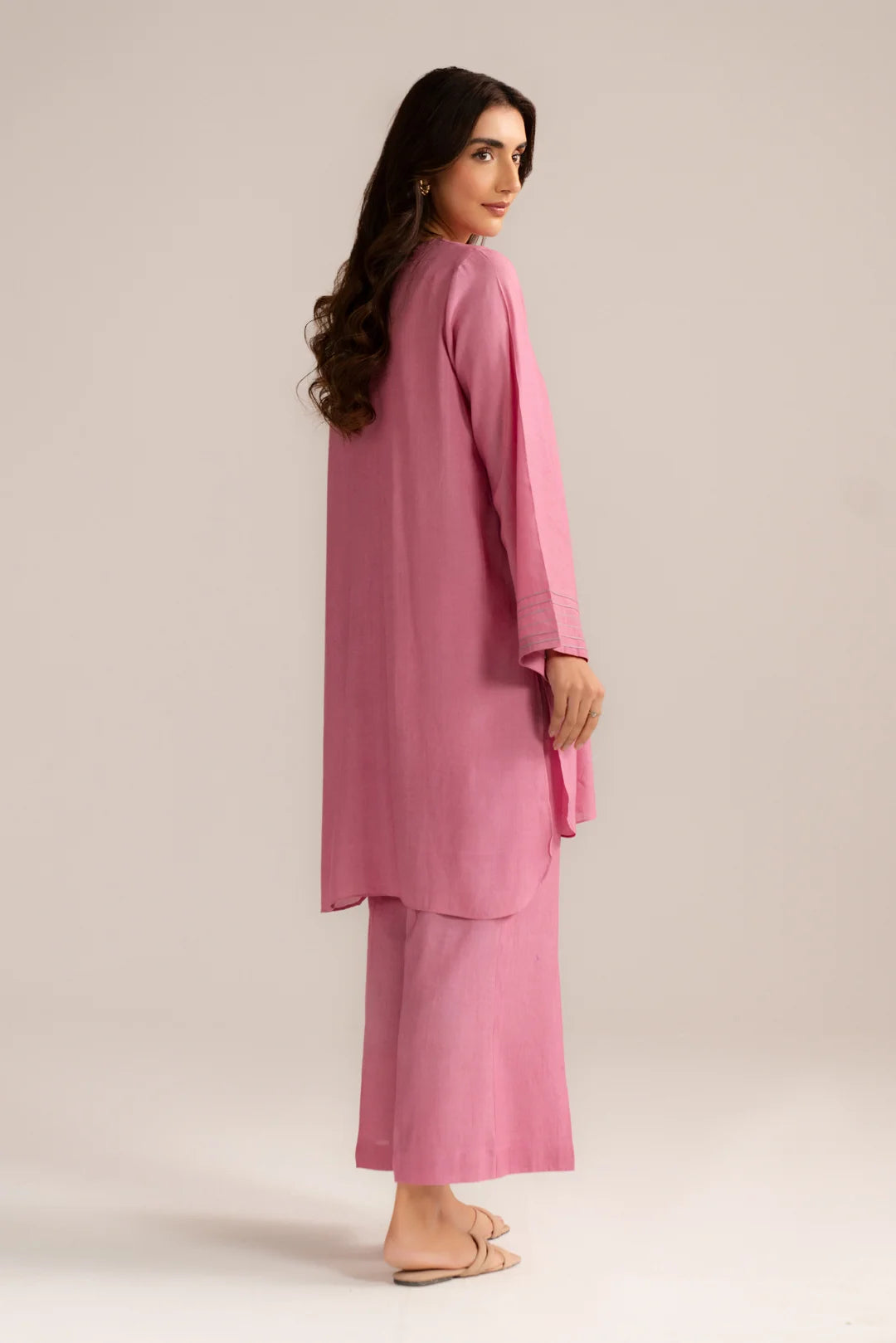 Side view of light pink women’s linen 2 piece suit with matching trousers