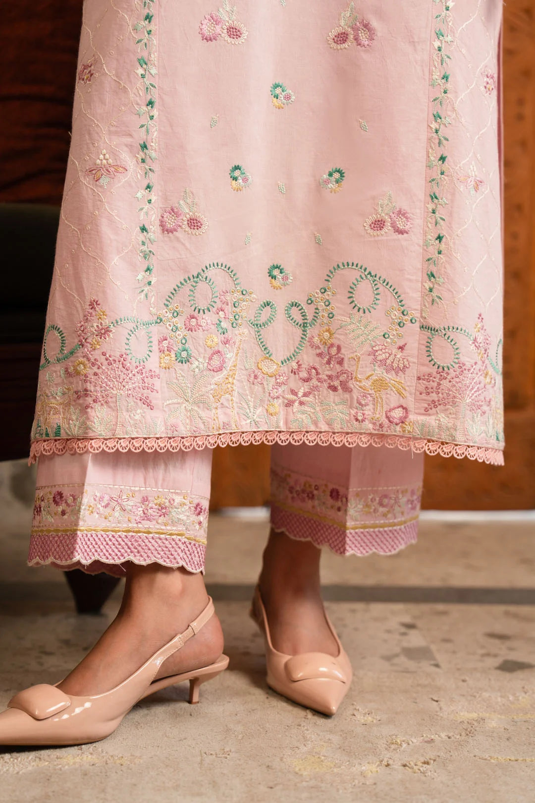 Side view of powder pink women embroidered pret suit