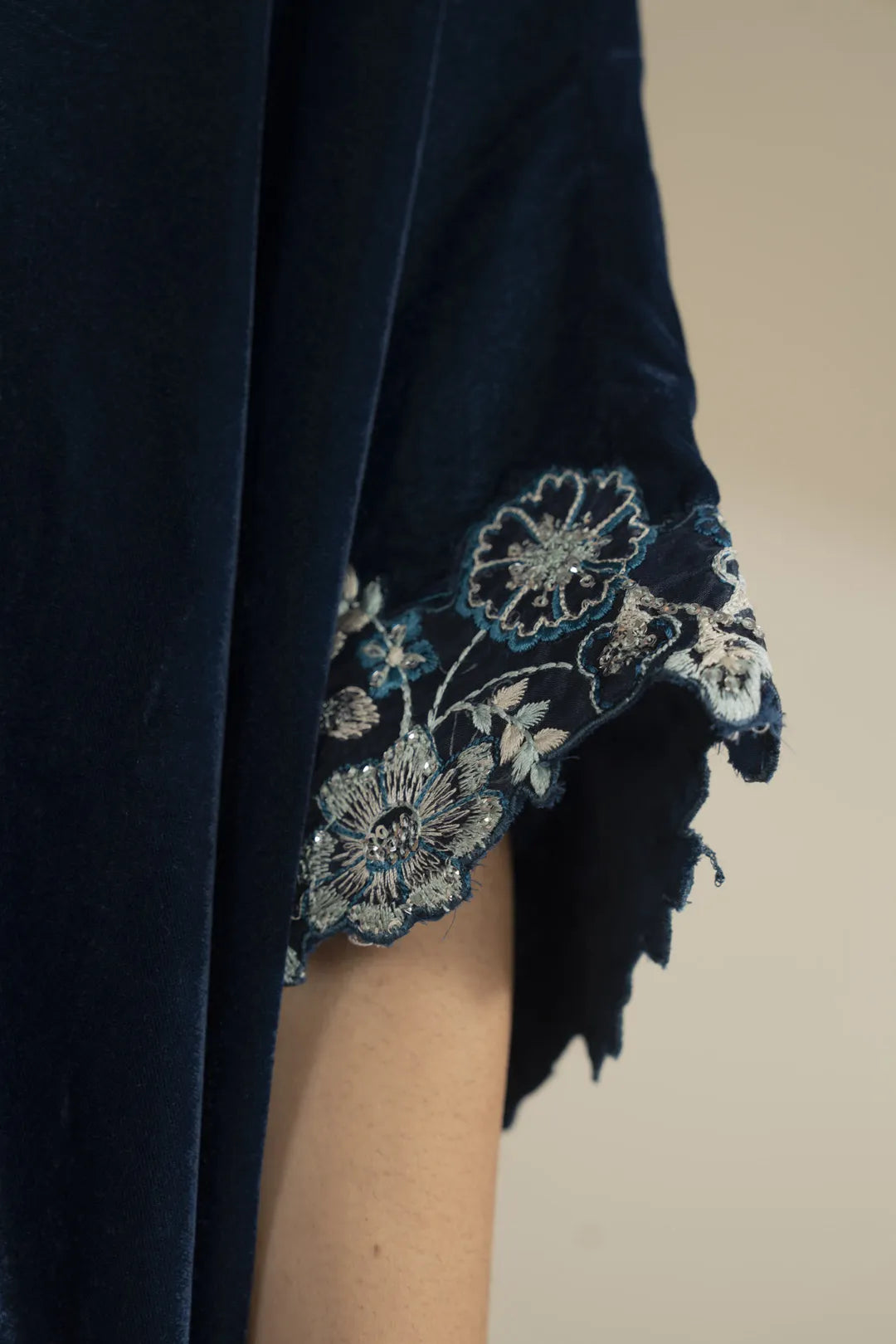 Sleeve-edge detail highlighting silver embroidery placement and velvet texture.