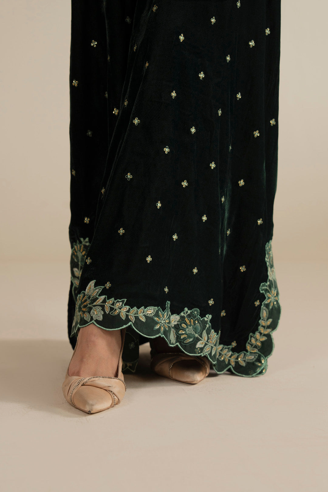 Sleeve detail on the velvet kaftan showing embroidered finishing and relaxed cut.
