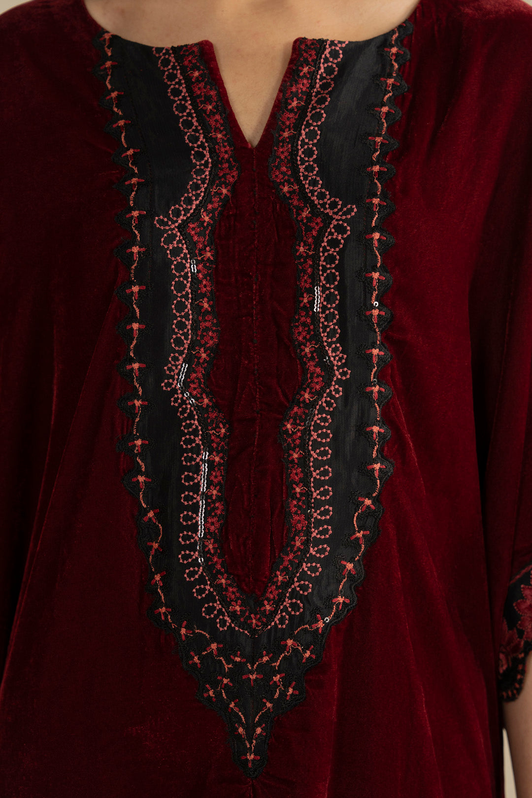 Sleeve detail shot showing embroidery placement and cuff finishing on velvet.