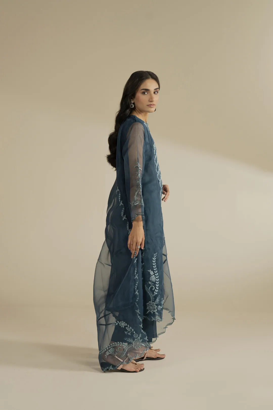 Sleeve detail showing fine threadwork embroidery on organza fabric