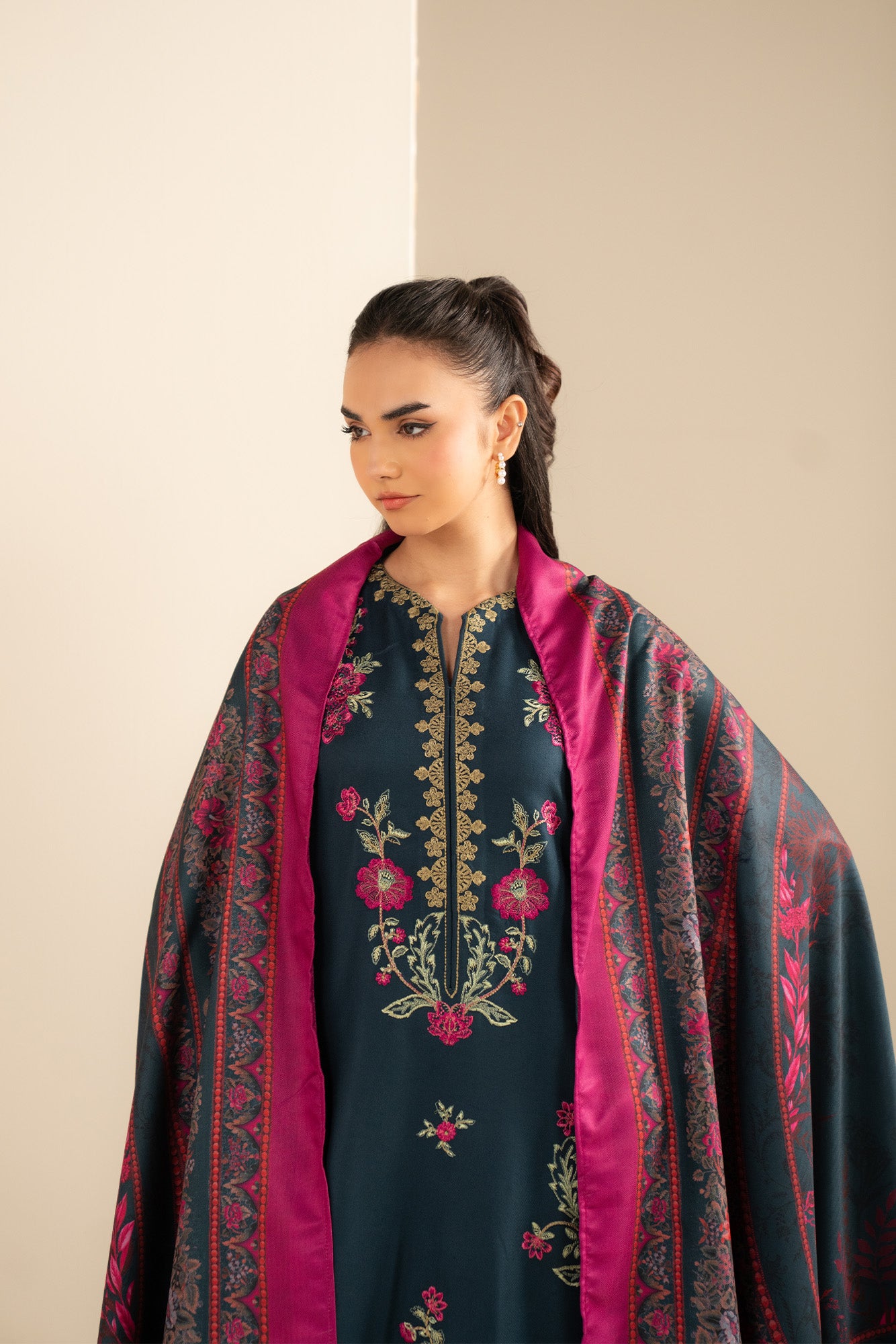 Sleeve embroidery close-up on Marina suit fabric.