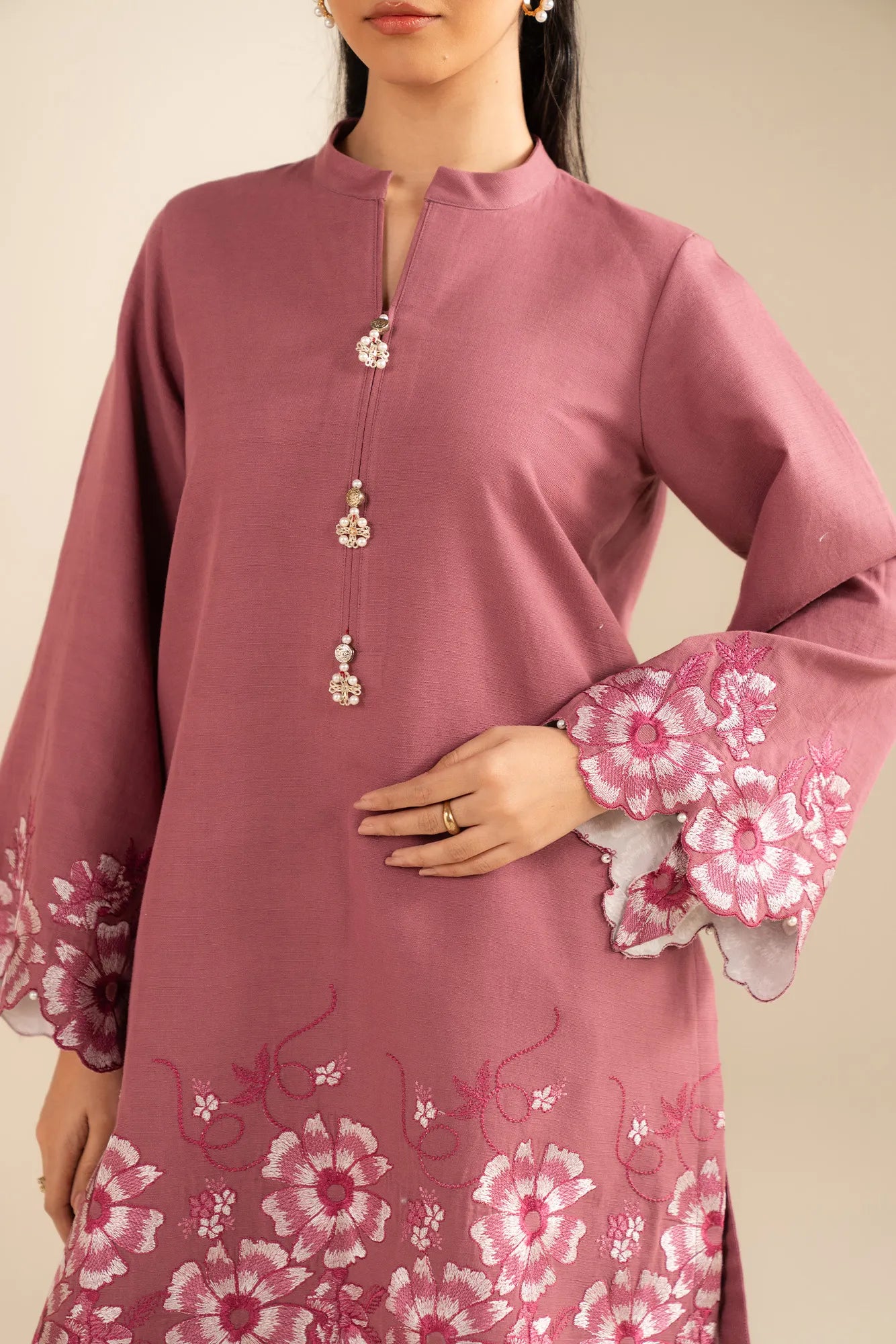 Sleeve embroidery detail on pink khaddar winter suit for women