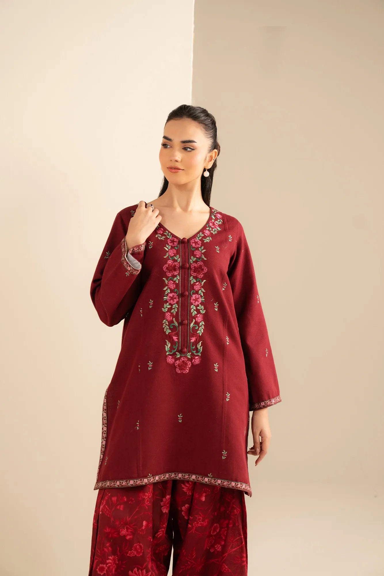 Sleeve embroidery detail on unstitched red khaddar shirt fabric