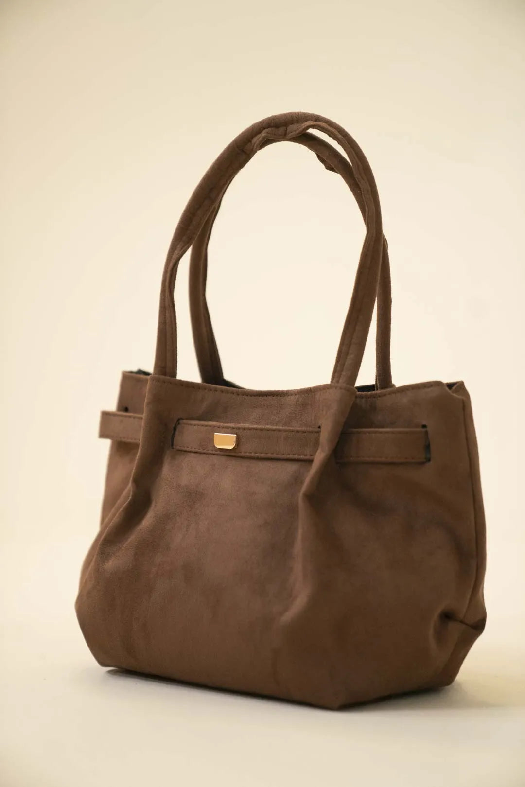 Soft brown shoulder handbag with a relaxed shape and spacious carryall design on a neutral background.