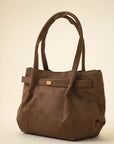 Soft brown shoulder handbag with a relaxed shape and spacious carryall design on a neutral background.