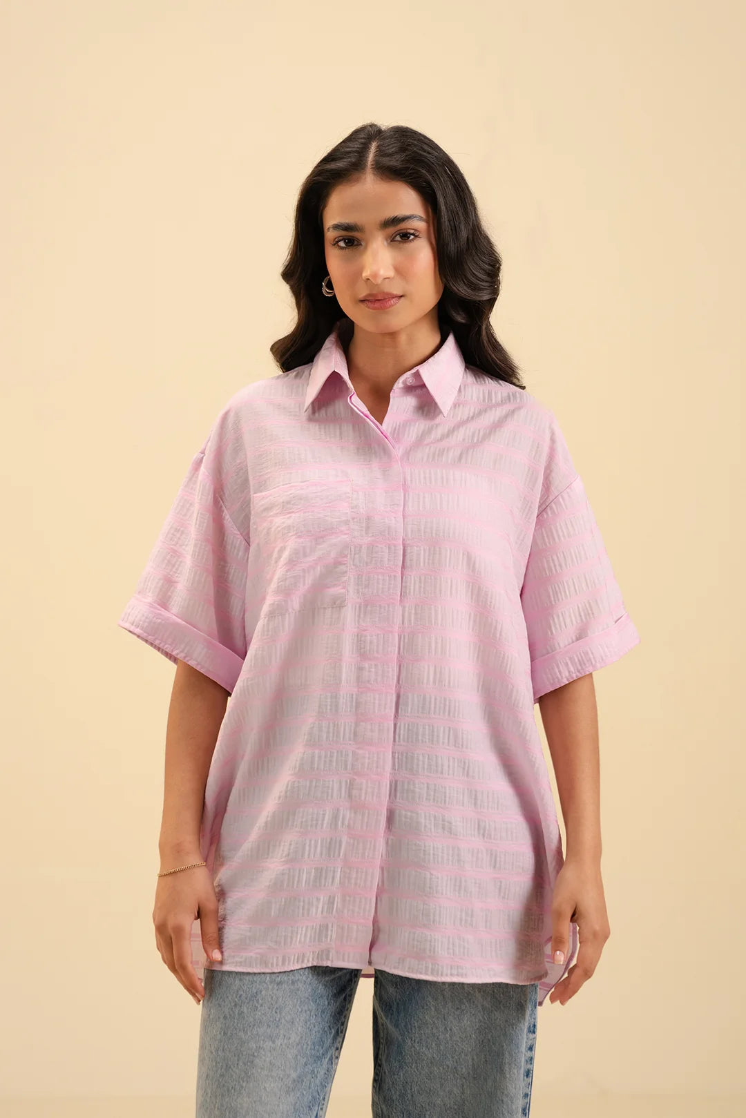Soft pink tailored shirt for women – chic and comfortable fashion staple.