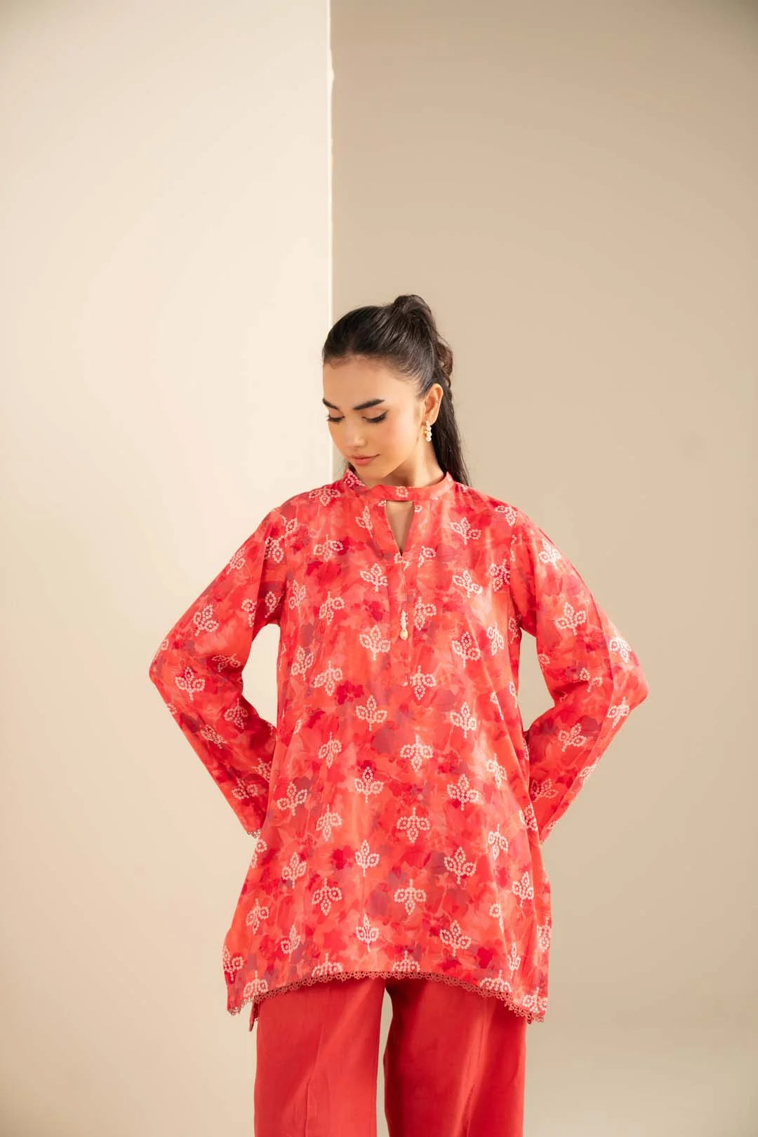 Straight-on look highlighting the bold all-over print and relaxed shirt silhouette with wide-leg trousers.