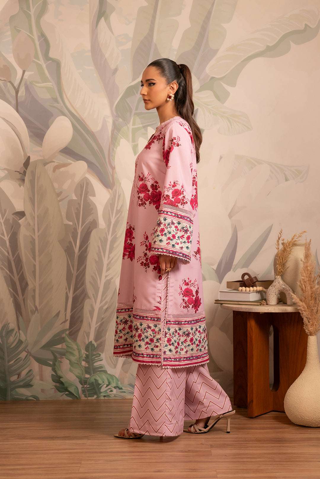 Top Pakistani cambric suit for women – soft pink floral shirt and matching pants with a trendy geometric design.