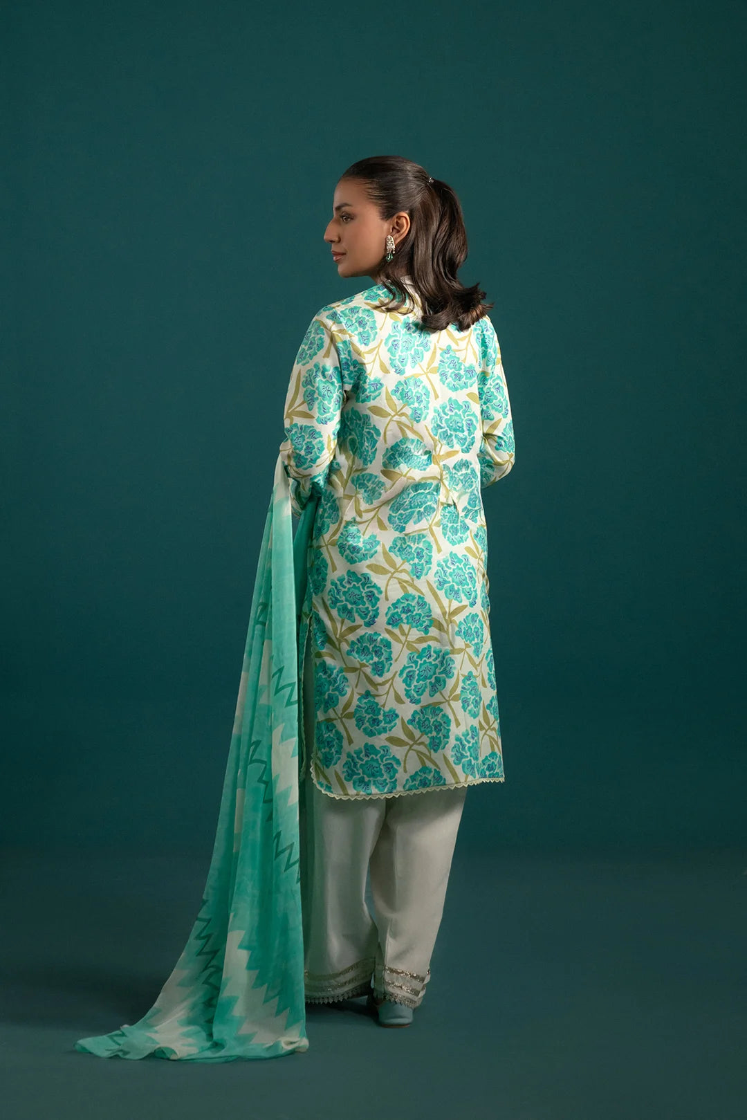 Trendy lawn suit design – a digitally printed floral lawn shirt with modern zigzag chiffon dupatta and solid dyed trouser for a sophisticated look.